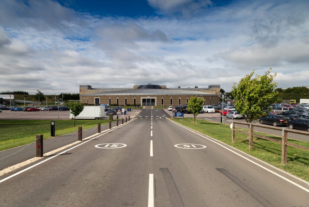 The British Motor Museum building at Gaydon, seen from the entrance road with the car park on either side