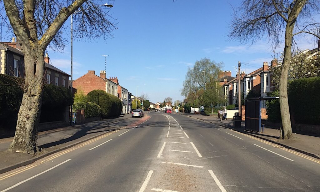 Emscote Road in Warwick, a wide tree-lined road with Victorian houses, almost empty of traffic